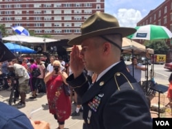 U.S. Army retired Combat Medic Chandler Davis stood in quiet salute for hours at a makeshift memorial outside the Dallas Police Headquarters, in Dallas, Texas, July 9, 2016.