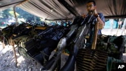 FILE - Weapons belonging to rebels of the Revolutionary Armed Forces of Colombia (FARC) are stored at a rebel camp in La Carmelita near Puerto Asis in Colombia's southwestern state of Putumayo, Feb. 28, 2017.