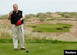 FILE - Donald Trump gestures as he stands at the 13th tee of his new Trump International Golf Links course on the Menie Estate near Aberdeen, northeast Scotland June 20, 2011.
