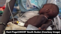 FILE - A child is treated for cholera in South Sudan. 