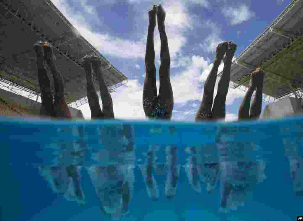 France&#39;s team dives into the pool during a training session of the Synchronised Swimming Olympic Games Qualification Tournament at the Maria Lenk Aquatics Center in Rio de Janeiro, Brazil. The tournament is also a test event for the Rio 2016 Olympics.