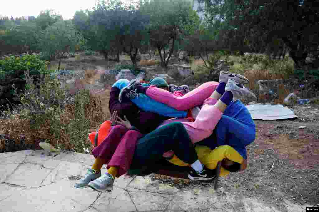 Dancers participate in a &quot;Bodies in Urban Spaces&quot; event choreographed by Austrian artist Willi Dorner as part of the Israel Festival in Jerusalem.