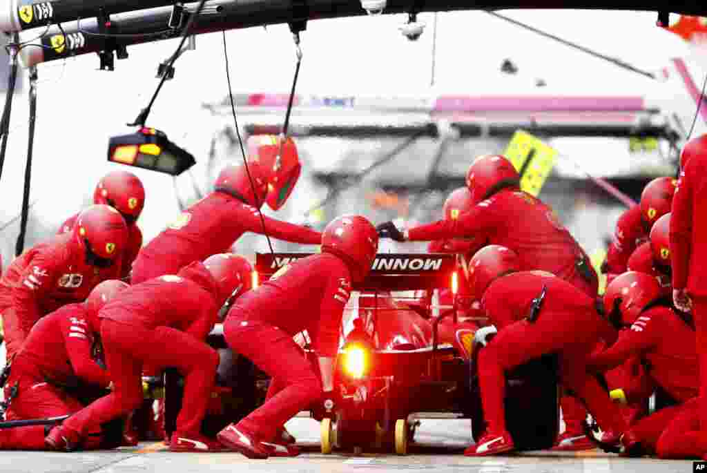 Pit crew work on the car of Ferrari driver Charles Leclerc of Monaco during the Formula One pre-season testing session at the Barcelona Catalunya racetrack in Montmelo, outside Barcelona, Spain. 