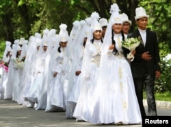FILE - Brides and grooms leave after a mass wedding ceremony in the Kyrgyz capital of Bishkek, May 7, 2011. The wedding, held for 20 couples who could not afford their own celebrations, was sponsored by the Kyrgyz government.