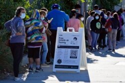 People line up at a COVID-19 testing center, in San Fernando, Calif., Jan. 5, 2022.