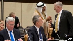 FILE - Saudi Arabia's Deputy Defense Minister Mohammed Alayeesh, second right, speaks with U.S. Secretary of Defense Jim Mattis, right, during a meeting of the counter-Islamic State Coalition at NATO headquarters in Brussels, Feb. 16, 2017.