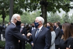 Democratic presidential candidate and former U.S. Vice President Joe Biden and Vice President Mike Pence greet each other during the 19th anniversary of the 9/11 attacks at the National September 11 Memorial & Museum in New York City