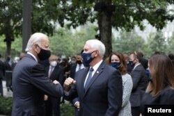 Democratic presidential candidate and former U.S. Vice President Joe Biden and Vice President Mike Pence greet each other during the 19th anniversary of the 9/11 attacks at the National September 11 Memorial & Museum in New York City