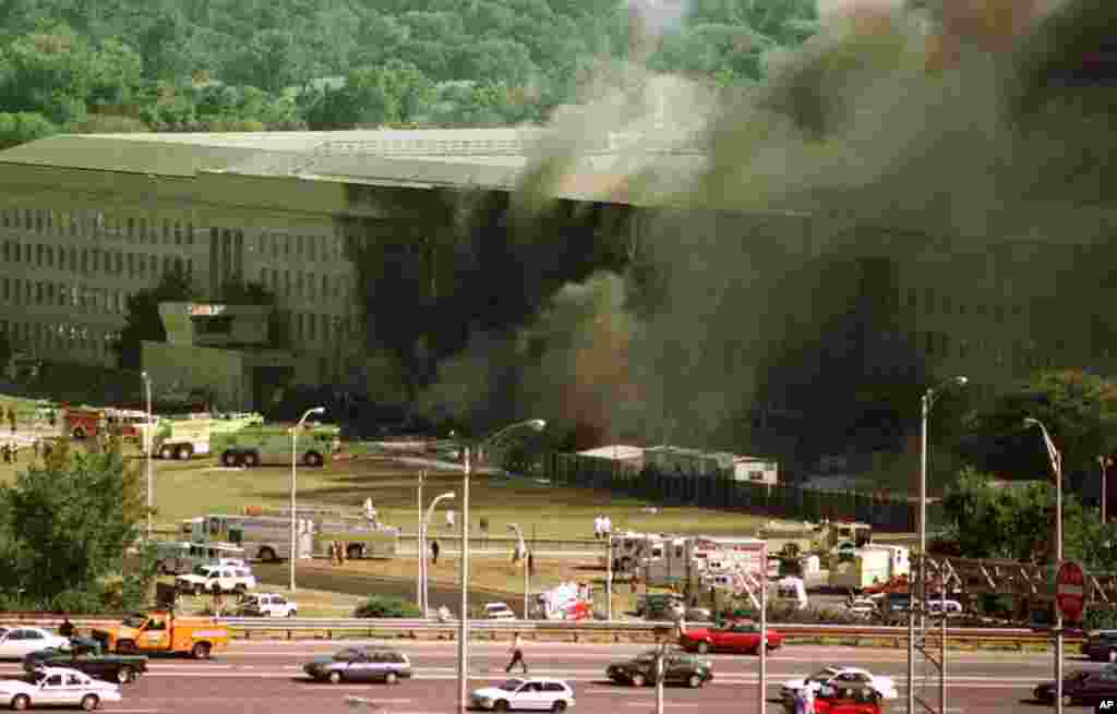 Vehicles are shown traveling on Interstate 395, leaving Washington, in front of the Pentagon, following an explosion Tuesday, Sept. 11, 2001. (AP Photo/Tom Horan)