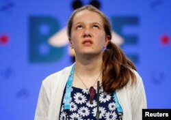 Sheridan Hennessy, 11, of Cincinnati, Ohio, ponders her answer during the 2017 Scripps National Spelling Bee at National Harbor in Oxon Hill, Md., May 31, 2017.