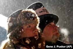 Jackie and Jimmy Wilson watch a fireworks display during the 132nd Groundhog Day on Gobbler's Knob in Punxsutawney, Pa. Friday, Feb. 2, 2018. (AP Photo/Gene J. Puskar)