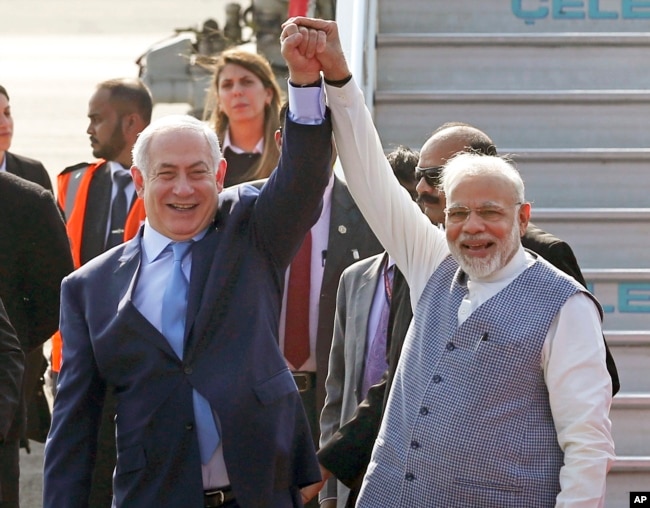 Israel's Prime Minister Benjamin Netanyahu, left, is welcomed by India's Prime Minister Narendra Modi on his arrival at Palam airport in New Delhi Sunday, Jan. 14, 2018.