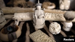 FILE - Ivory carvings seized by the U.K. Border Force at Heathrow Airport sit on display at Custom House near Heathrow in London, Britain, Nov. 22, 2017. 