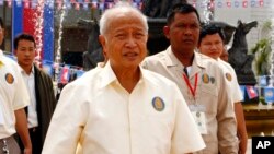 Cambodia's Prince Norodom Ranariddh, foreground, of royalist Funcinpec party walks after his party's congress in Phnom Penh, Cambodia, Monday, Jan. 19, 2015. 