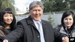 Former PM and Russia's favored candidate, Almazbek Atambayev (C), who was declared winner of Kyrgyzstan's presidential elections, talks to journalists in the capital Bishkek, October 31, 2011.