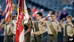 A color guard of Boy Scouts from the Chief Seattle Council salute during the national anthem before a baseball game between the Seattle Mariners and Houston Astros in Seattle, May 25, 2014.