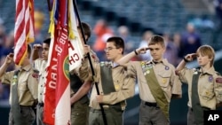 FILE - A color guard of Boy Scouts from the Chief Seattle Council salute during the national anthem before a baseball game between the Seattle Mariners and Houston Astros in Seattle, May 25, 2014.
