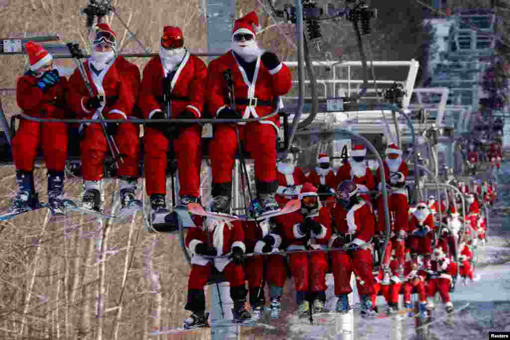 Skiers dressed as Santa Claus ride the lifts to take part in the charity Santa Sunday at Sunday River ski resort in Bethel, Maine, Dec. 5, 2021.