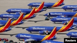 FILE - A number of grounded Southwest Airlines Boeing 737 MAX 8 aircraft are shown parked at Victorville Airport in Victorville, California, March 26, 2019.