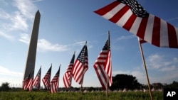 FILE - U.S. flags representing suicides of active and veteran members of the military line the National Mall in Washington, Oct. 3, 2018. U.S. suicide rates have been rising for nearly 20 years, aside from a two-year drop around the beginning of the COVID-19 pandemic.