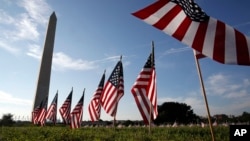 U.S. flags representing suicides of active and veteran members of the military line the National Mall, Oct. 3, 2018. The suicide rate among female veterans is lower than that of male veterans, but female veterans are almost twice as likely to kill themselves as civilian women.