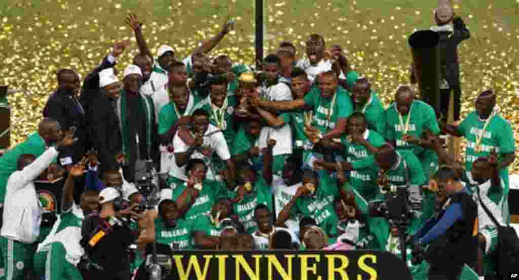 Nigeria's soccer team hold the trophy as they celebrate after winning the African Cup of Nations final soccer match against Burkina Faso at Soccer City Stadium in Johannesburg, South Africa, Sunday Feb. 10, 2013. (AP Photo/Themba Hadebe)