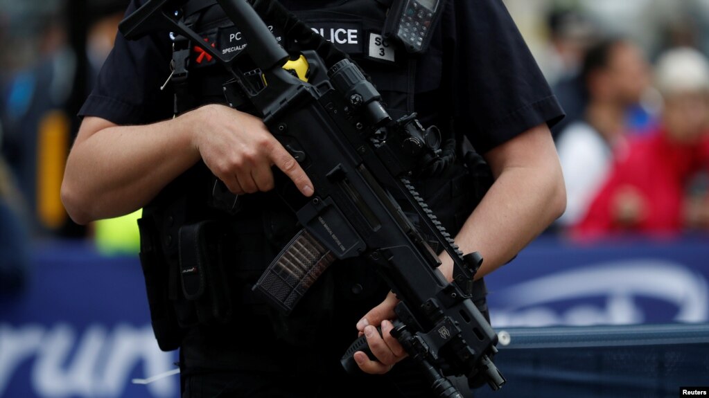 Armed police officers keep watch over junior runners competing in the Great Manchester Run in central Manchester, May 28, 2017. 