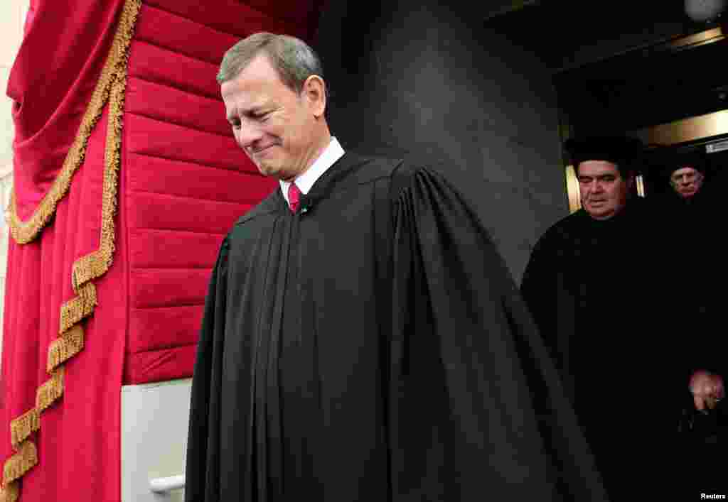 Supreme Court Chief Justice John Roberts is followed by Supreme Court Justice Antonin Scalia as they arrive for the presidential inauguration on the West Front of the U.S. Capitol in Washington January 21, 2013