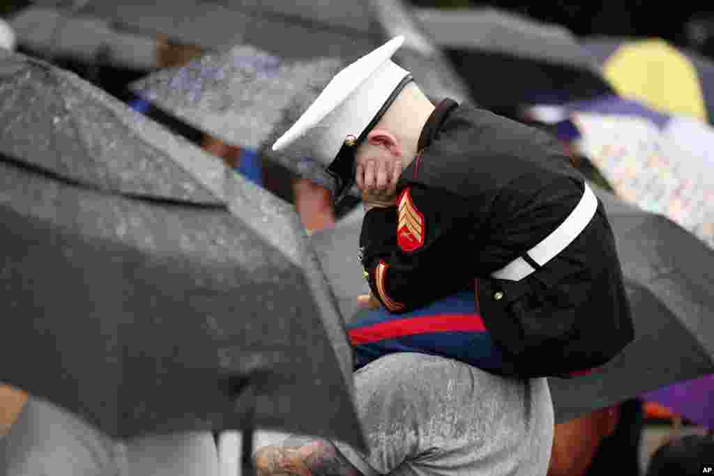 Christian Jacobs waits in the rain for President Donald Trump at the Fourth of July picnic for military families on the South Lawn of the White House in Washington, July 4, 2017.