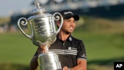 Jason Day, of Australia, holds up the Wanamaker Trophy after winning the PGA Championship golf tournament Sunday, Aug. 16, 2015, at Whistling Straits in Haven, Wis.
