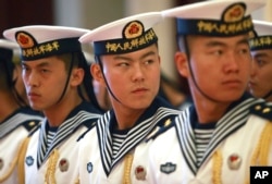 FILE - Members of a military honor guard are seen at People's Liberation Army Navy headquarters outside Beijing, China.