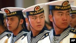 FILE - Members of a military honor guard are seen at People's Liberation Army Navy headquarters outside Beijing, China, July 15, 2014. Despite tensions over China's territorial claims over the South China Sea, Beijing and Washington continue to engage in