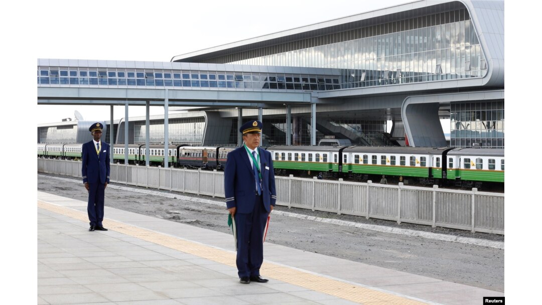 FILE - Kenya Railways attendants prepare to receive a train launched to operate on Standard Gauge Railway line constructed by the China Road and Bridge Corporation and financed by the Chinese government as it arrives at Nairobi Terminus, May 31, 2017.
