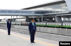 FILE - Kenya Railways attendants prepare to receive a train launched to operate on Standard Gauge Railway line constructed by the China Road and Bridge Corporation and financed by the Chinese government as it arrives at Nairobi Terminus, May 31, 2017.