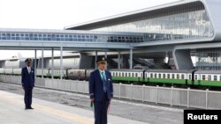 FILE - Kenya Railways attendants prepare to receive a train launched to operate on Standard Gauge Railway line constructed by the China Road and Bridge Corporation (CRBC) and financed by Chinese government as it arrives at the Nairobi Terminus, May 31, 2017.