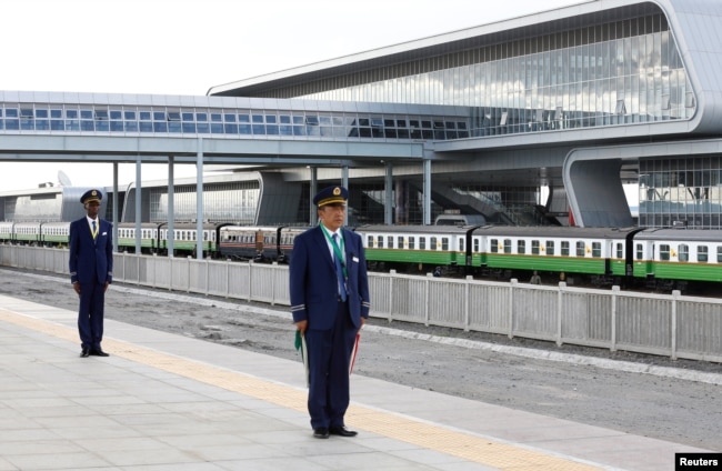 FILE - Kenya Railways attendants prepare to receive a train launched to operate on Standard Gauge Railway line constructed by the China Road and Bridge Corporation (CRBC) and financed by Chinese government as it arrives at the Nairobi Terminus.