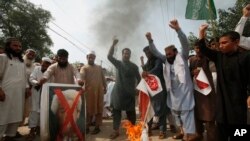 Pakistani protesters shout slogans to condemn a cartoon contest by Dutch parliamentarian, in Peshawar, Pakistan, Aug. 17, 2018.