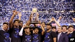 Duke players celebrate with the trophy after their 68-63 victory over Wisconsin in the NCAA Final Four college basketball tournament championship game Monday, April 6, 2015.