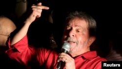 Former Brazilian President Luiz Inacio Lula da Silva gestures during a demonstration supporting his appointment to a Cabinet post, in Sao Paulo, Brazil, March 18, 2016. A Supreme Court justice late in the day blocked him from the post, citing constitutional grounds.