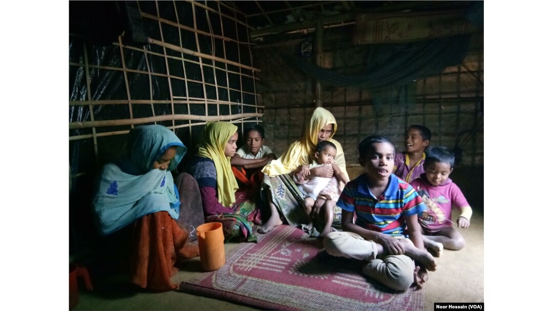Samsun Nahar, a Rohingya widow, along with her 9 children at her bamboo-and-plastic shack in a refugee colony in Kutupalong, Cox’s Bazar, Bangladesh