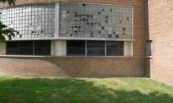 Broken windows are seen outside Cody High School in Detroit on Friday, Aug. 20, 2021. (AP Photo/Carlos Osorio)