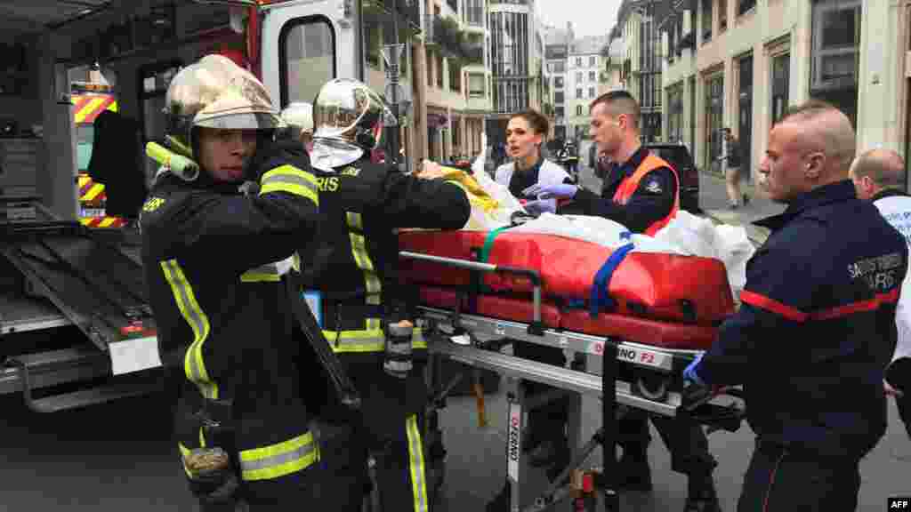 Les pompiers transportent un blessé sur une civière après une fusillade dans les bureaux parisiens de Charlie Hebdo, un hebdomadaire satirique, le 7 janvier 2015.