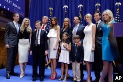 FILE - Donald Trump, fourth left, poses with his family after his announcement that he will run for president of the United States, in the lobby of Trump Tower, New York, June 16, 2015.
