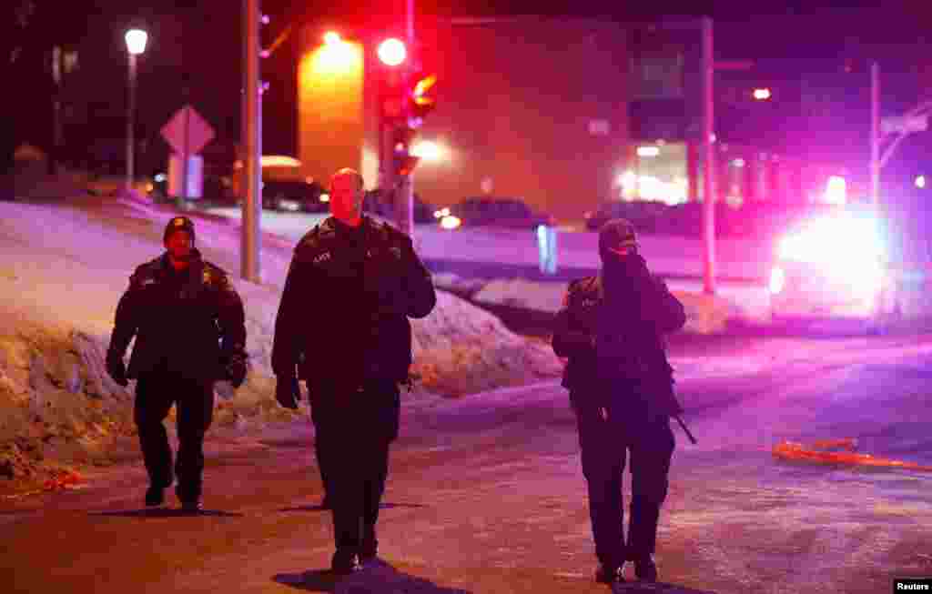 Polisi berpatroli di dekat masjid yang menghadapi penembakan di Quebec City (30/1). (Reuters/Mathieu Belanger)