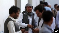 Afghans mourn a victim of a deadly suicide bombing that targeted a training class in a private building in the Shiite neighborhood of Dasht-i Barcha, in western Kabul, Afghanistan, Aug. 15, 2018. On Thursday, there was a new attack on the Afghan intelligence service in Kabul.