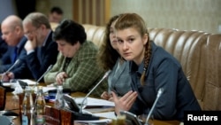 FILE - Public figure Maria Butina (R) attends a meeting of a group of experts, affiliated to the government of Russia, in this undated handout photo obtained by Reuters on July 17, 2018. 