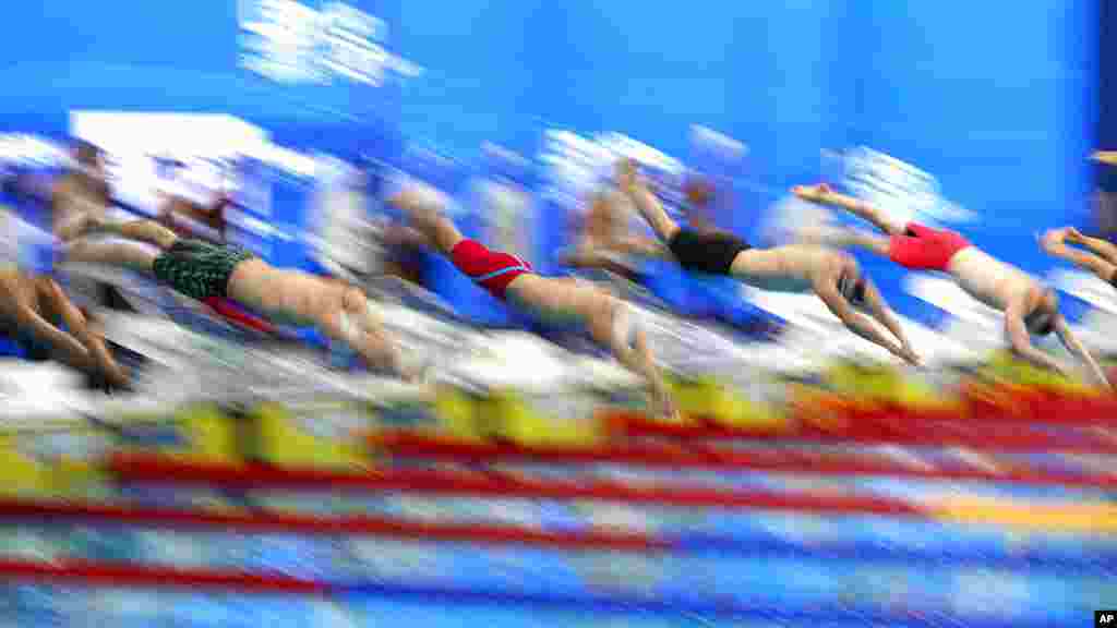 Swimmers jump in the pool at the beginning of the 400-meter relay men&#39;s final at the European Aquatics Championships in the Duna Arena in Budapest, Hungary.