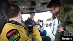 Prime Minister Justin Trudeau, center, prepares to fly over devastation from a wildfire during a visit to Fort McMurray, Alberta, Canada, May 13, 2016. 
