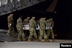A U.S. Army carry team transfers the remains of Army Staff Sgt. Dustin Wright of Lyons, Georgia, at Dover Air Force Base in Delaware on October 5, 2017.