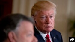 President Donald Trump, right, listens as Colombian President Juan Manuel Santos, left, speaks during a news conference in the East Room of the White House, in Washington, May 18, 2017.